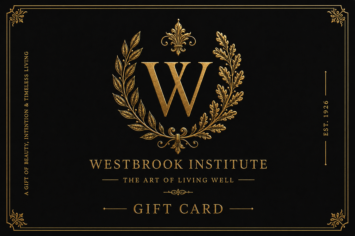 A black gift card featuring an ornate gold crest with a large letter W inside a laurel wreath, with the text 'WESTBROOK INSTITUTE', 'THE ART OF LIVING WELL', and 'GIFT CARD' in gold.