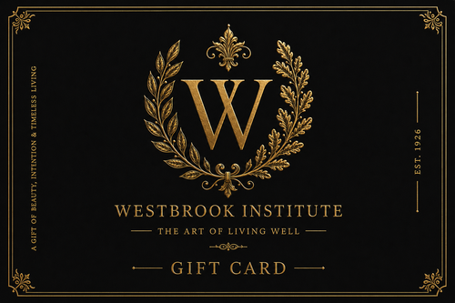 A black gift card featuring an ornate gold crest with a large letter W inside a laurel wreath, with the text 'WESTBROOK INSTITUTE', 'THE ART OF LIVING WELL', and 'GIFT CARD' in gold.